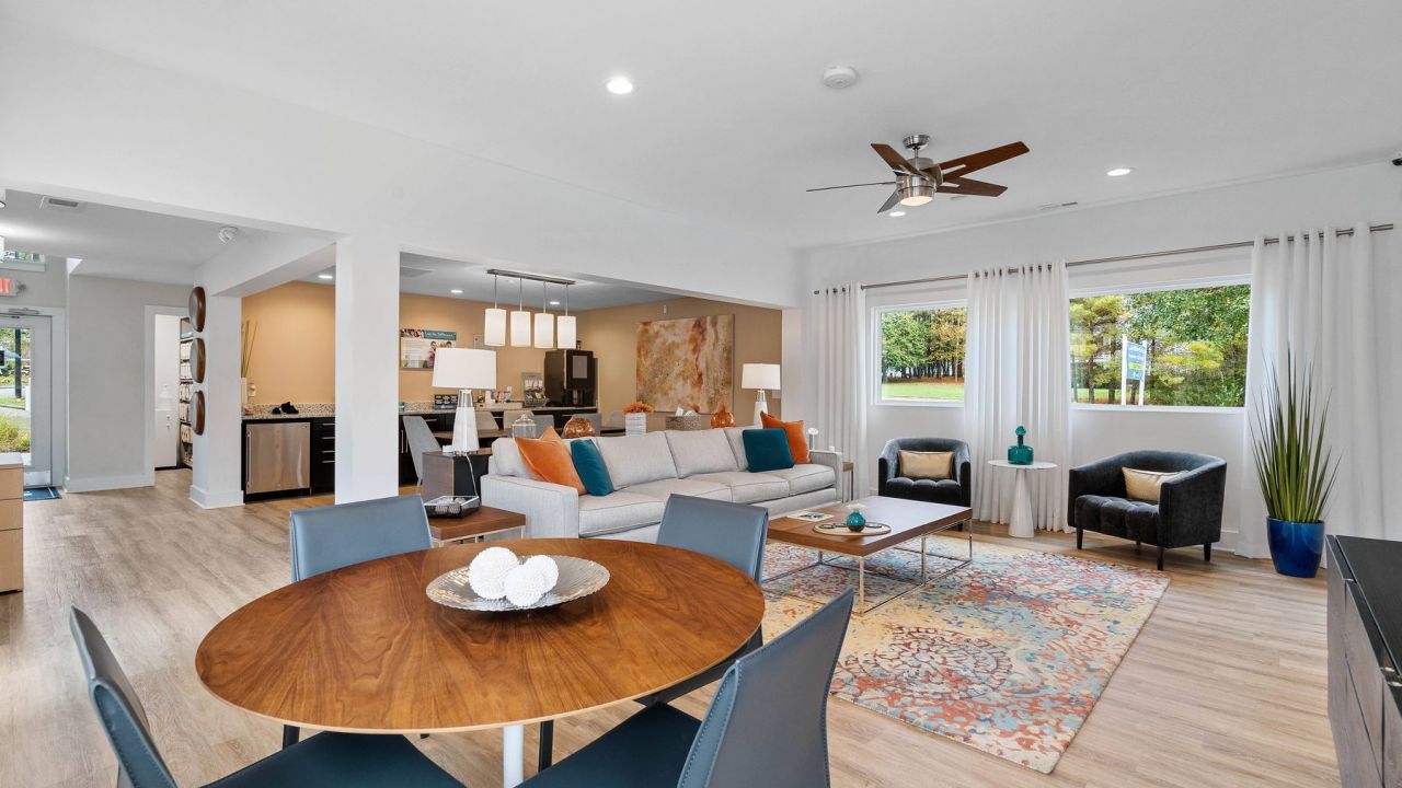 Hawthorne Oak Ridge Clubhouse with dining table, ceiling fan, rug, couch, chairs, and coffee table
